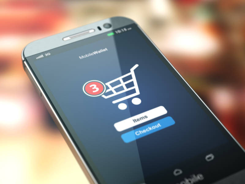 Online shopping concept. Mobile phone or smartphone with cart on