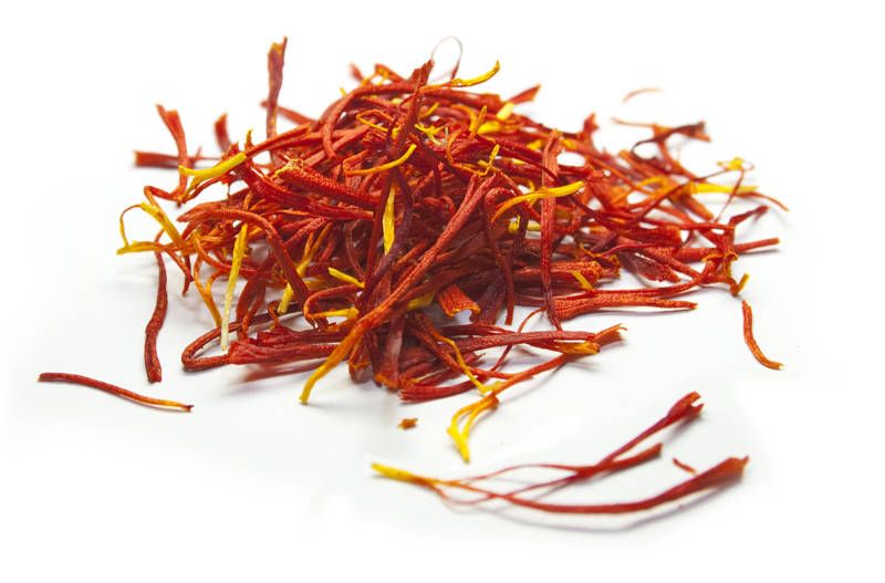 Close up photo of a pile of red saffron threads.